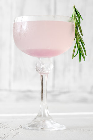 Purple Sunset Cocktail garnished with rosemary sprigの写真素材