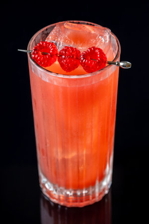 Punch cocktail garnished with raspberriesの写真素材
