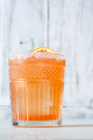Blood Orange Margarita cocktail garnished with orange wheelの写真素材