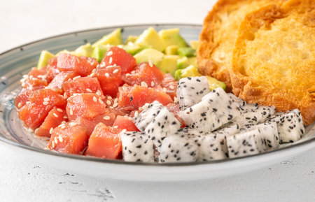 Portion of Hawaiian poke with tuna, pitaya and avocadoの写真素材