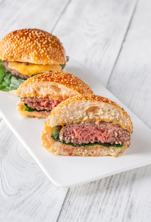 Two homemade cheeseburges on the wooden backgroundの写真素材