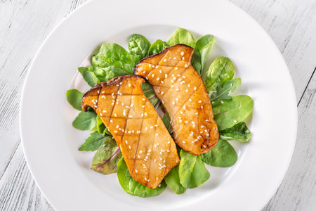 Portion of fried eryngii mushrooms with saladの写真素材