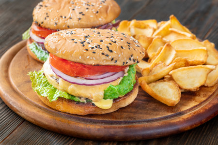 Two homemade hamburgers served with potato dippersの写真素材