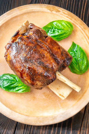 Glazed cooked pork hock on the plateの写真素材