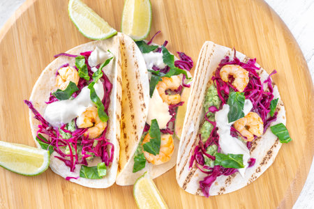 Tacos with shrimp, red cabbage, guacamole and sour creamの写真素材