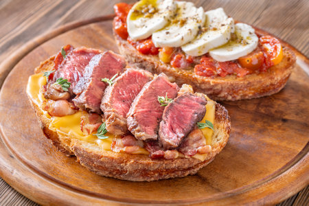 Mozzarella tomato and beef steak bacon bruschettasの写真素材