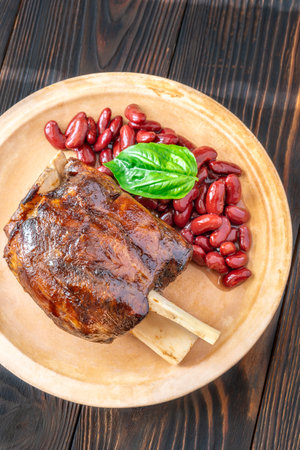 Glazed cooked pork hock with kidney beansの写真素材