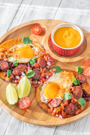 Chorizo and egg tostadas with cheddar cheese sauceの写真素材