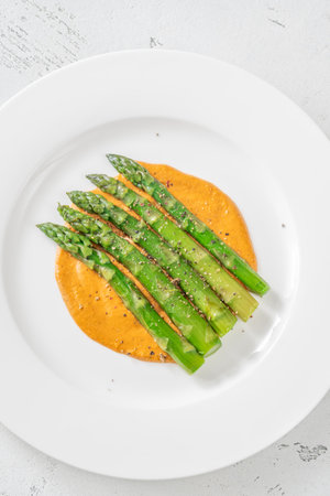 Coocked asparagus with romesco sauce on the plateの写真素材