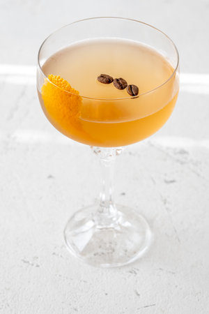 Cocktail garnished with orange zest and coffee beansの写真素材