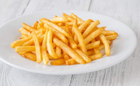 Crisp edges and golden glow highlight the irresistible simplicity of classic friesの写真素材