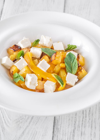 Sweet pineapple, grilled peppers, feta cubes, and mint mingle in vibrant salad