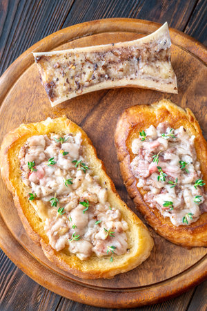 Herb-topped marrow melts into toasted bread, offering bold and buttery rustic indulgenceの写真素材
