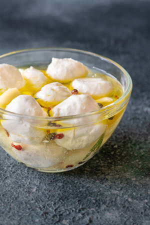Golden oil swirls around creamy labneh, peppercorns and herbs infuse rustic charmの写真素材