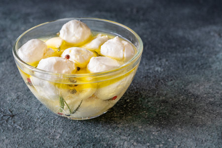 Golden oil swirls around creamy labneh, peppercorns and herbs infuse rustic charmの写真素材