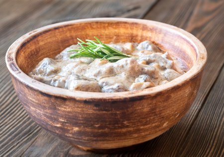 Creamy beef stroganoff with tender meat, rich sauce, and fragrant rosemary garnishの写真素材