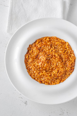 Tomato risotto plated simply with vibrant warmthの写真素材