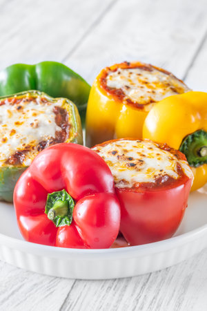 Vibrant bell peppers are baked to perfection, generously stuffed with rich bolognese sauce, and crowned with melted mozzarellaの写真素材