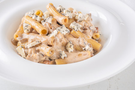 Soft penne coated in rich walnut sauce with crumbled sharp blue cheeseの写真素材
