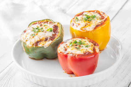 Vibrant bell peppers are baked to perfection, generously stuffed with rich bolognese sauce, and crowned with melted mozzarellaの写真素材