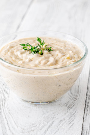 Herbed sauce glows softly as thyme floats atop rich, tangy blue cheeseの写真素材