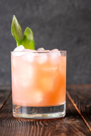 Vibrant drink blends guava, pineapple, lime, and rum in rich tropical harmonyの写真素材