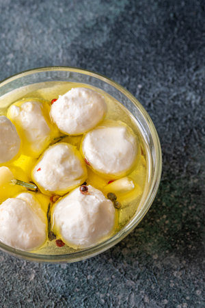 Golden oil swirls around creamy labneh, peppercorns and herbs infuse rustic charmの写真素材