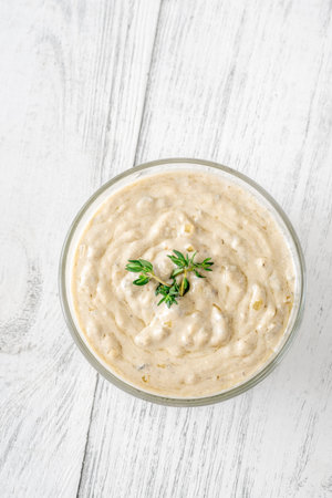 Herbed sauce glows softly as thyme floats atop rich, tangy blue cheeseの写真素材