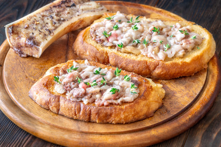 Herb-topped marrow melts into toasted bread, offering bold and buttery rustic indulgenceの写真素材