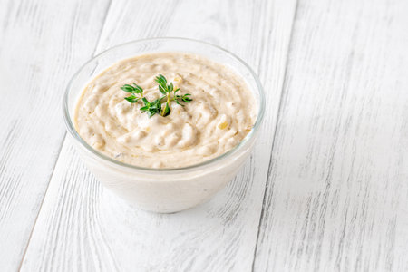 Herbed sauce glows softly as thyme floats atop rich, tangy blue cheeseの写真素材