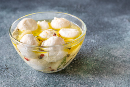 Golden oil swirls around creamy labneh, peppercorns and herbs infuse rustic charmの写真素材
