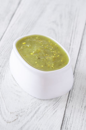 Bright green salsa verde swirled into bowl, tangy flavor with smooth textureの写真素材