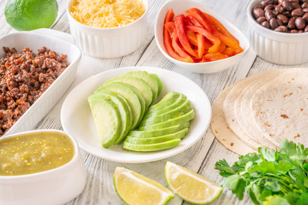 Tortillas surrounded by vibrant toppings and fillings, ready to assemble flavorful tacosの写真素材