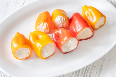 Red, orange, yellow peppers filled with creamy cheeseâa crisp, vibrant appetizer treatの写真素材