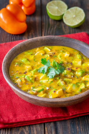 Avocado, mango, red onion, and lime combine in vibrant handcrafted salsa bowlの写真素材