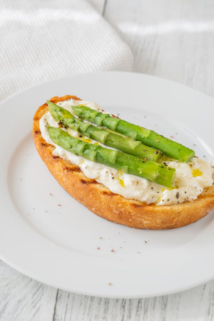Toasted sandwich filled with creamy stracciatella and crisp asparagus spearsの写真素材