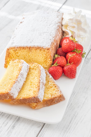 Golden pound cake with fresh strawberries, fluffy whipped cream, served for dessertの写真素材
