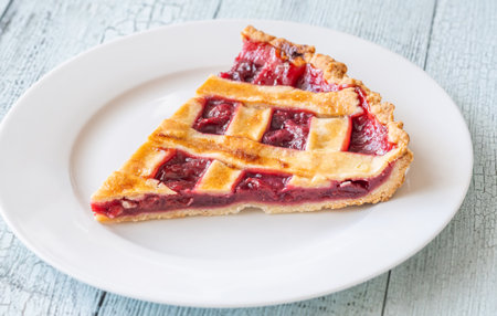 Glossy red filling peeks through golden crust, radiating warmth and simple homemade sweetnessの写真素材