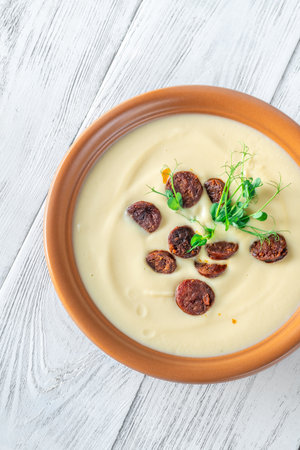 Soft textures meet crisp sprouts as rich chorizo adds warmth to the creamy inviting soupの写真素材