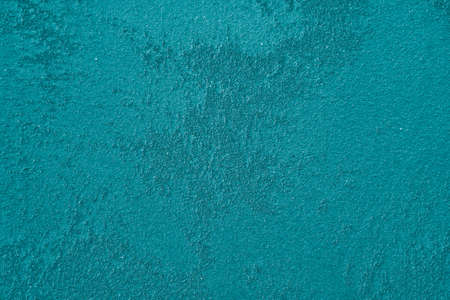 Coarse-grained wall surface not evenly painted with large strokes of paint, backgroundの写真素材