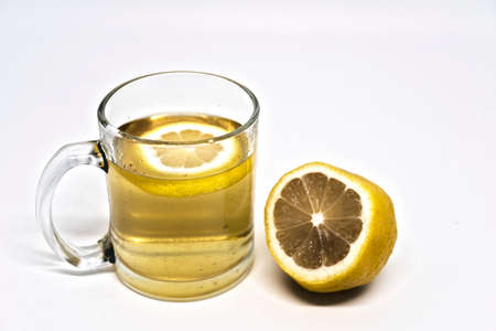 A glass of green tea with lemon and a slice of lemon, hot tea is the best cold medicineの写真素材
