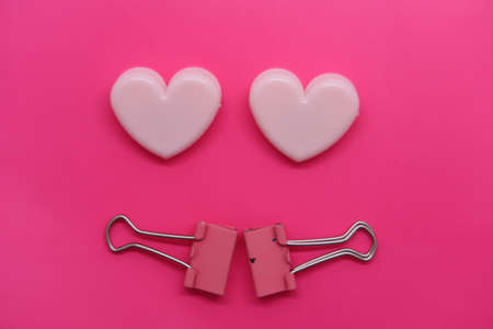 Heart-shaped paper clips, pink on roseの写真素材