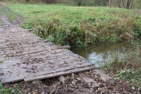 Wooden bridge over a river, autumn
