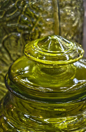 Decorative glass lid on a large green bottleの写真素材