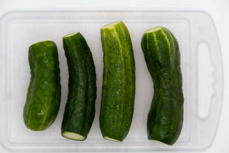 Washed green soil cucumbers for saladの写真素材