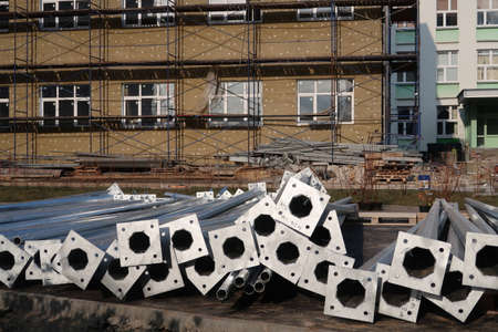 Steel flag masts lie on a construction siteの写真素材