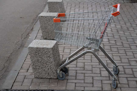 Empty grocery cart parked at the mallの写真素材