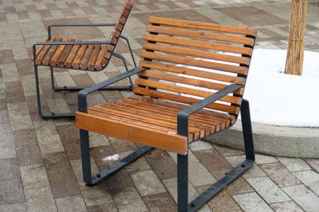 Wooden chairs of an outdoor cafe on the background of the first snow, Moscowの写真素材