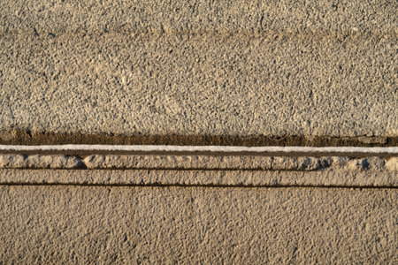 A thin layer of snow at the junction of large massive stone blocks, minimalismの写真素材