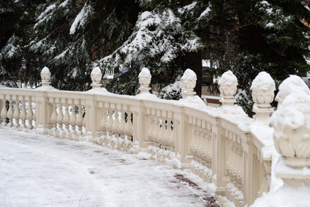 Snow covered round veranda with stone balusters